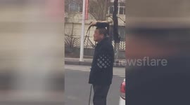 Man takes giant tortoise for a walk by placing it upside-down on his head