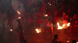 Hindu devotees take part in religious fire-throwing festival