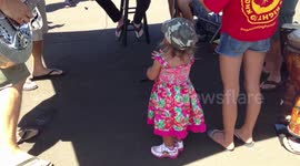Little Hawaiian girl dances to musicians