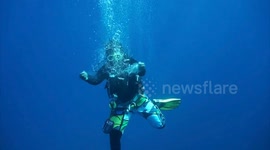 Diver making bubbles with their hands
