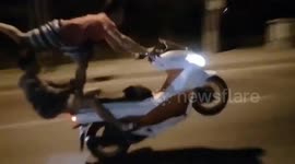 Man surfs on moped while performing wheelie in heart-stopping stunt