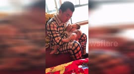 'Kung fu' baby kicks leg when drinking milk