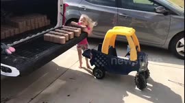 Little Girl Helps Father Haul Brick