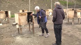 Trapper the Husky in his kennel with visitors - Basecamp Trapper's Station
