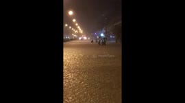People walking through flooded road