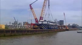 New pier for Trinity Buoy Wharf in London being lowered in to the River Thames by a crane