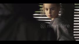 Two kids recreate a battle scene from Star Wars on an outdoor lounge