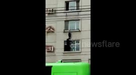 Sanitation worker plucks girl hanging from third floor window clothesline