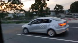 The baby was driving the car while her mom was using the phone on the highway