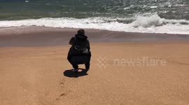 Man filming Atlantic Ocean
