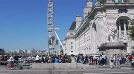People crossing Westminster Bridge, London Eye, House of commons by jim connor