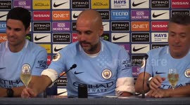 Guardiola celebrates winning Premier League title with champagne