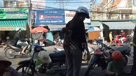 The woman brings the dog on her back go to the market