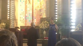 Couple at church with singing lady
