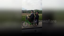 University graduates pick bicycle over limousine on their big day