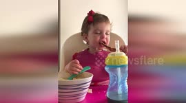 Little girl can't decide whether to sleep or eat