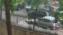 Garbage can strikes cars in sudden Greece rainstorm