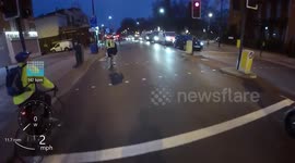 Group of cyclists racing each other continuously jump red lights in fast and dangerous way