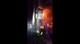 The man uses water extinguishes the fire in the high-voltage cabinet
