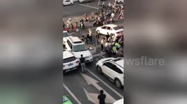 Erratic SUV driver crashes into scooter riders waiting at traffic lights