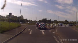 Biker with no helmet, no number plate & no lights and in wrong lane, undertakes at roundabout during busy rush hour traffic