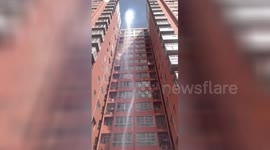 Dust devil whirls in front of residential building on couple's wedding day