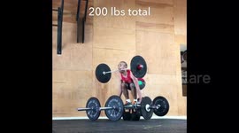 See if a man can lift 200 pounds with one of the barbells in his mouth