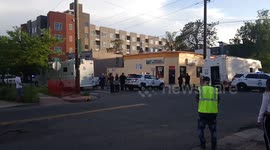 Police standoff with swat team negotiating with a suspect with a gun and 2 hostages.