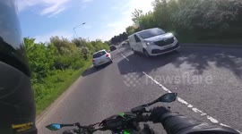 Cut up at roundabout. Sheepish apology. Motorbike vs car