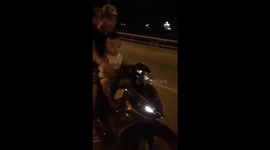The boy four-year-old rides a motorbike at high speed on the road