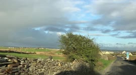 Irish countryside, green grass and cloudy sky