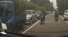 Passing moped rider hurls chunk of metal at car windscreen in Taiwan