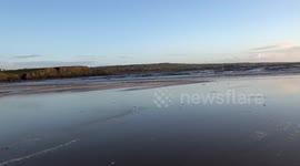Walking on the sandy beach by the ocean