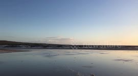 Walking on the sandy beach by the ocean