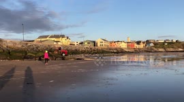 Walking on the sandy beach by the ocean