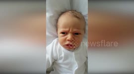 Baby with ridiculously expressive face doesn't like it when dad wakes him up