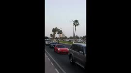 Standing on motorbike at Qatar car parade during Ramadan