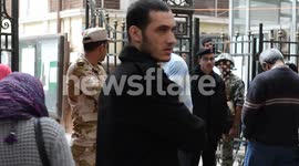 Egyptians enter polling station during controversial constitutional referendum
