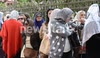 Women queue outside a polling station for Egypt's constitutional referendum