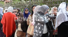 Women queue outside a polling station for Egypt's constitutional referendum