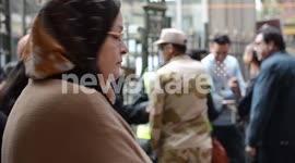 Egyptians queue outside the entrance of a polling station during constitutional referendum