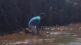 Man kisses huge wild crocodile