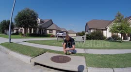 Boy catches fish in a storm drain outside his house