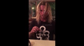 Hot man plays with adorable kitten at cafe in Costa Rica