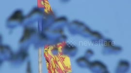 The Royal Standard flying on the Windsor Castle showing the queen is in residence from the park by the Dimond jubilee fountain in the center of Windsor by Jim Connor
