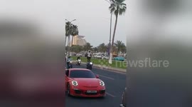 Newsflare Edit - Newsflare Edit - Standing on motorbike at Qatar car parade during Ramadan