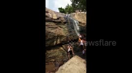 Teen survives terrifying slip down 30ft waterfall