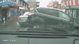 Out-of-control car slams into waiting vehicle after reversing across UK high street