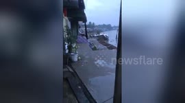 Terrifying moment houses swept away into river by landslides