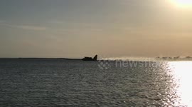 Water bombers skim lake to refill during Canada forest fires